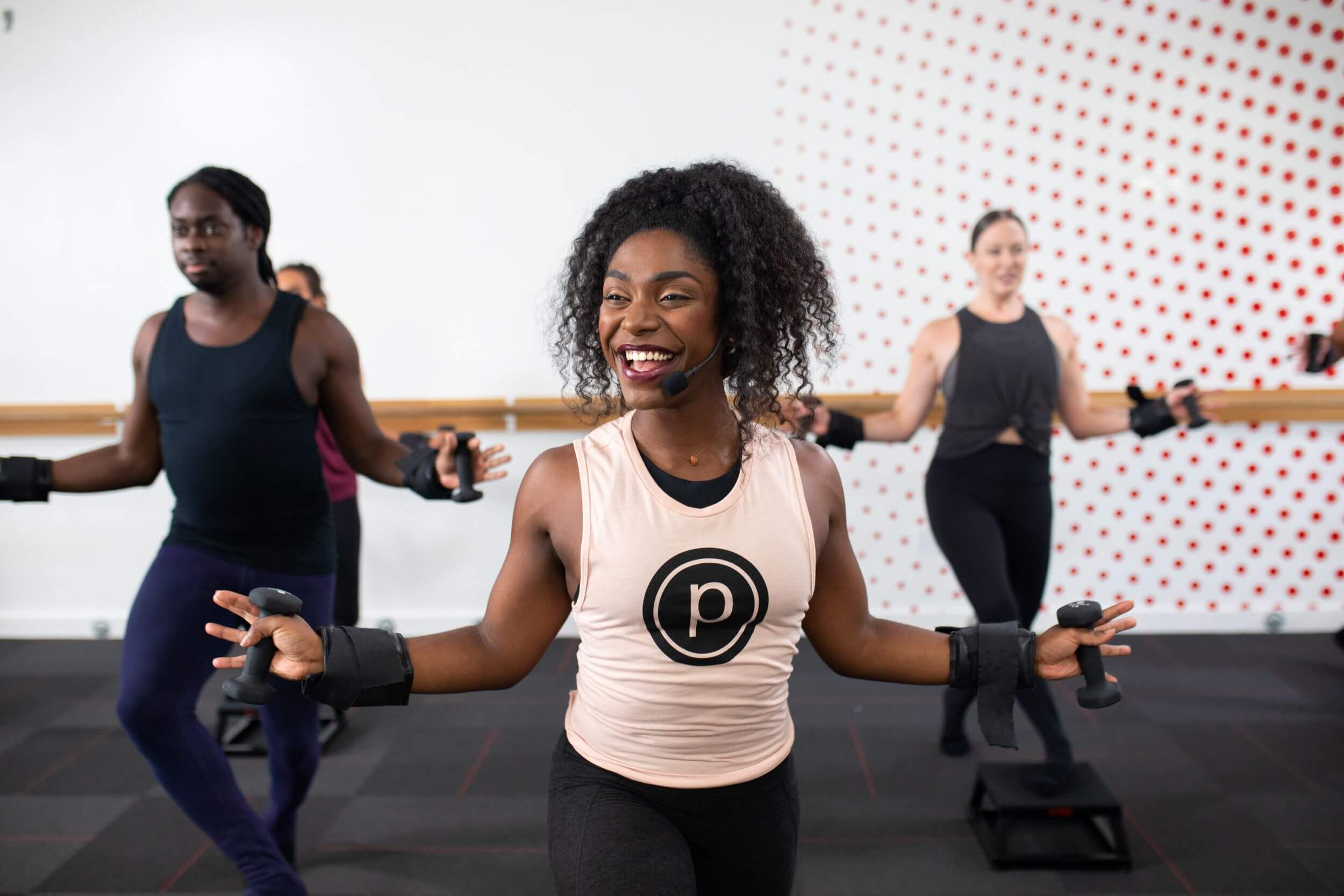 Group working out with wrist weights and dumbbells